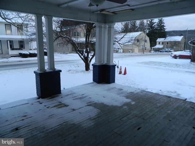 snow covered deck featuring ceiling fan