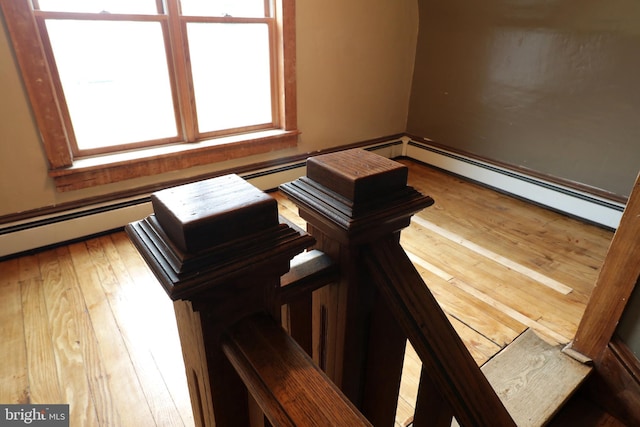 miscellaneous room with hardwood / wood-style flooring, plenty of natural light, and a baseboard heating unit