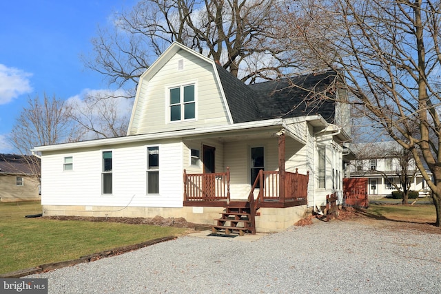 view of front of home with covered porch and a front lawn