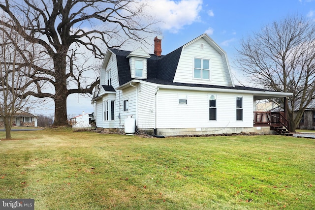 rear view of house featuring a yard