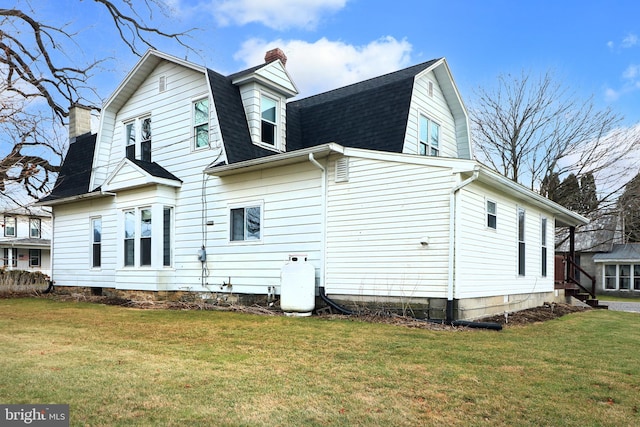 back of house with a yard