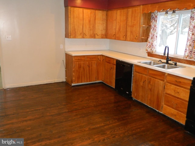 kitchen with dark hardwood / wood-style flooring, black appliances, and sink