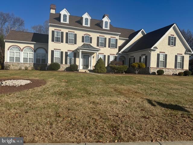 colonial inspired home with a front yard