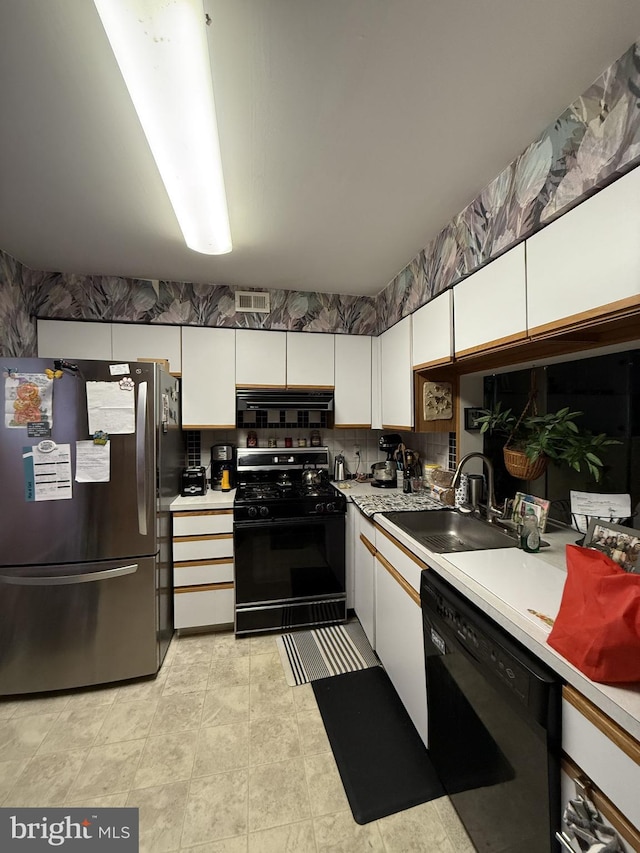 kitchen featuring white cabinetry, sink, tasteful backsplash, and black appliances