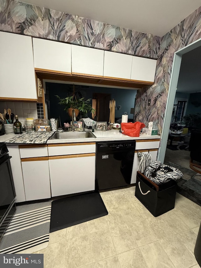 kitchen with white cabinets, sink, and black dishwasher