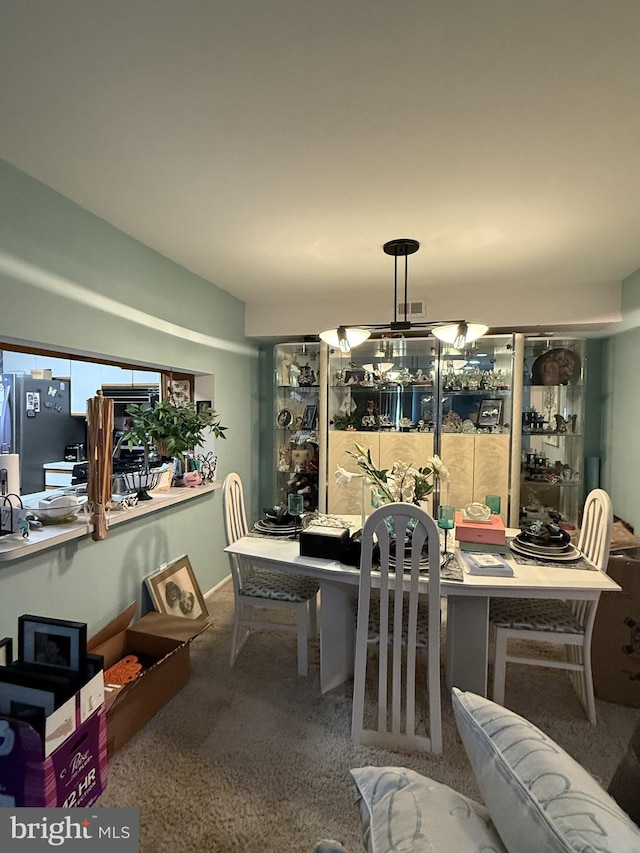 dining area featuring an inviting chandelier