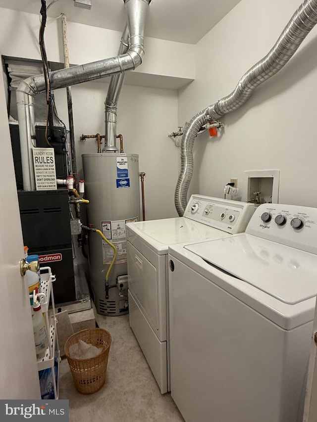 laundry room featuring gas water heater and washing machine and clothes dryer