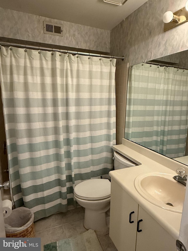 bathroom with vanity, tile patterned floors, and toilet