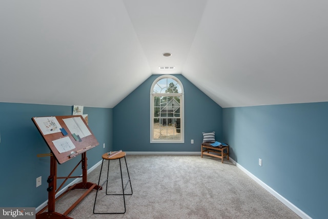 interior space with carpet flooring and vaulted ceiling