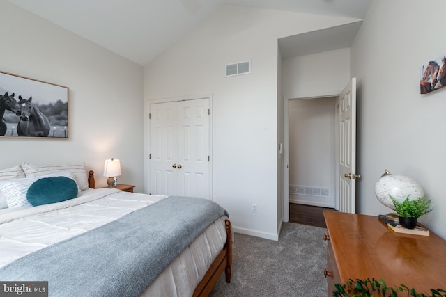 carpeted bedroom with a closet and vaulted ceiling