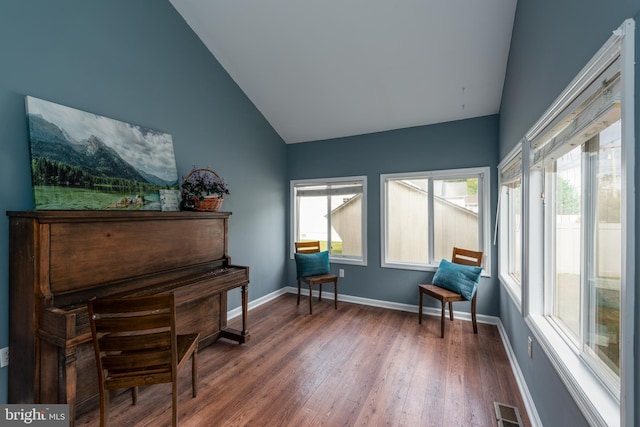 sitting room featuring high vaulted ceiling and dark hardwood / wood-style floors