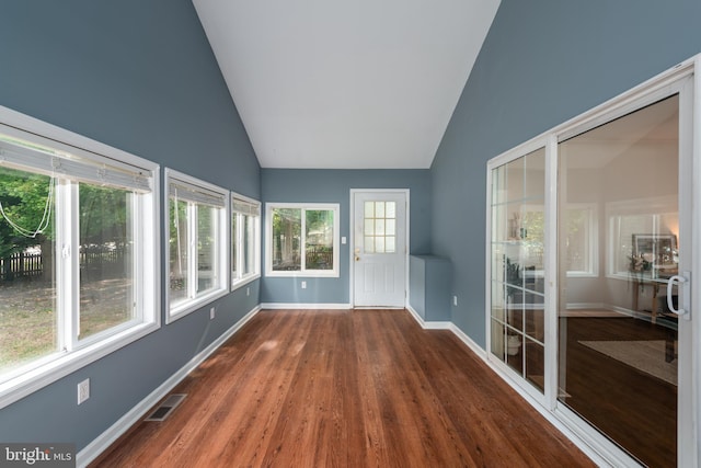 unfurnished sunroom featuring vaulted ceiling