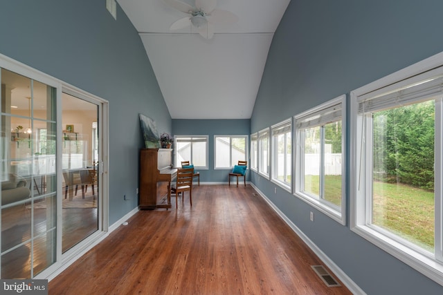 unfurnished sunroom featuring vaulted ceiling, plenty of natural light, and ceiling fan