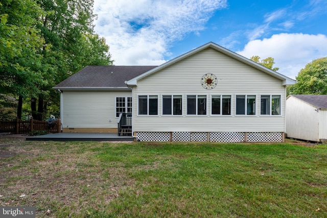 rear view of house featuring a patio and a lawn