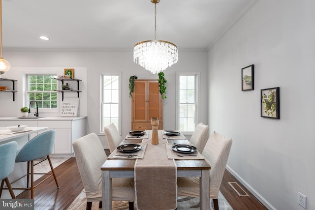 dining space featuring dark hardwood / wood-style flooring, sink, and a wealth of natural light