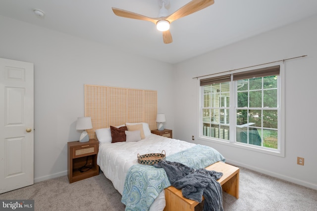 bedroom with ceiling fan and light colored carpet