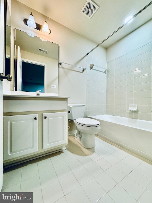 full bathroom featuring toilet, tile patterned floors, vanity, and tiled shower / bath combo