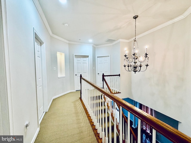 hallway with carpet, an inviting chandelier, and crown molding