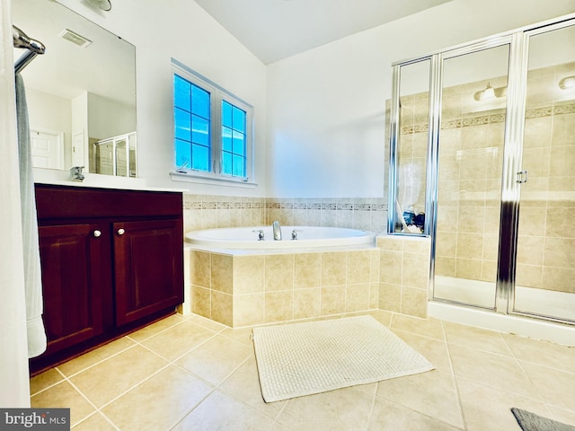 bathroom with tile patterned floors, vanity, and independent shower and bath