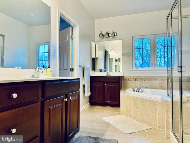 bathroom with tile patterned floors, plus walk in shower, plenty of natural light, and vanity