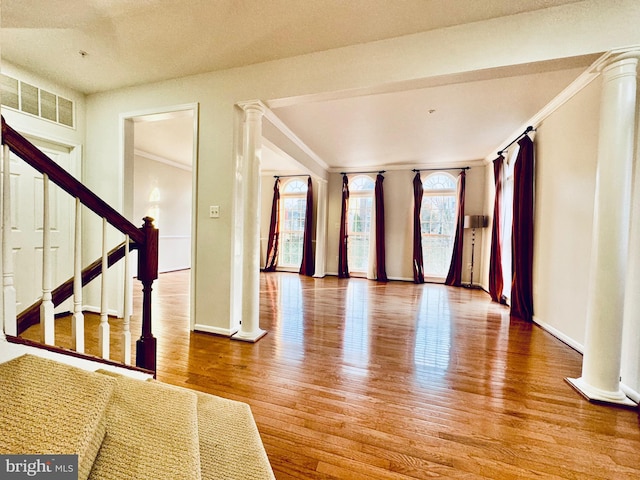 interior space featuring hardwood / wood-style floors and crown molding