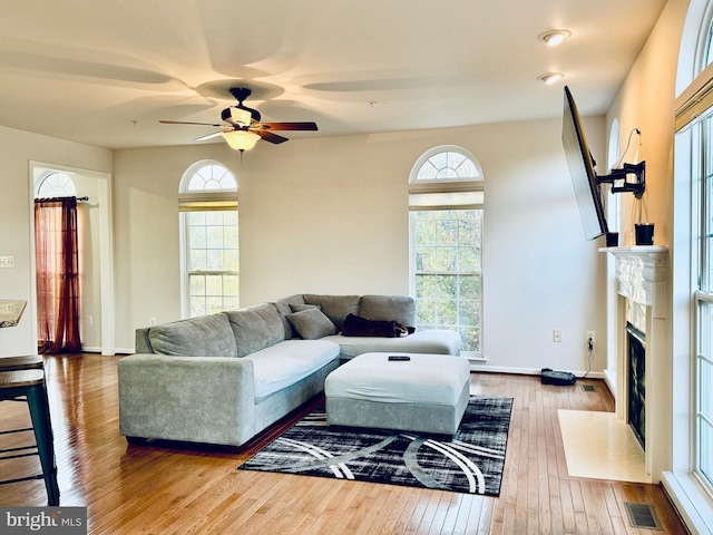 living room featuring hardwood / wood-style floors and ceiling fan