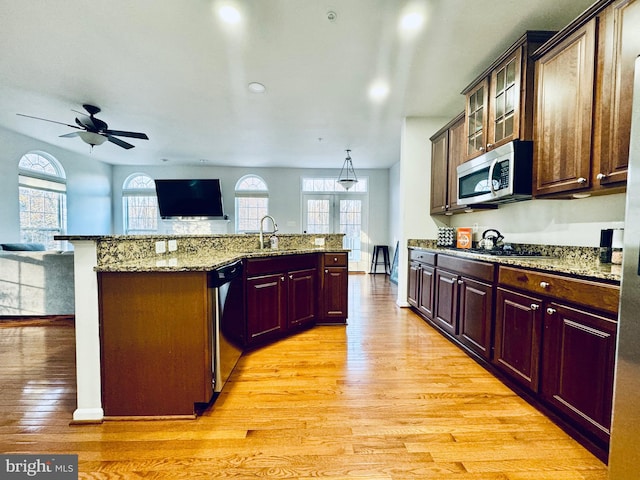 kitchen with sink, stainless steel appliances, and light wood-type flooring