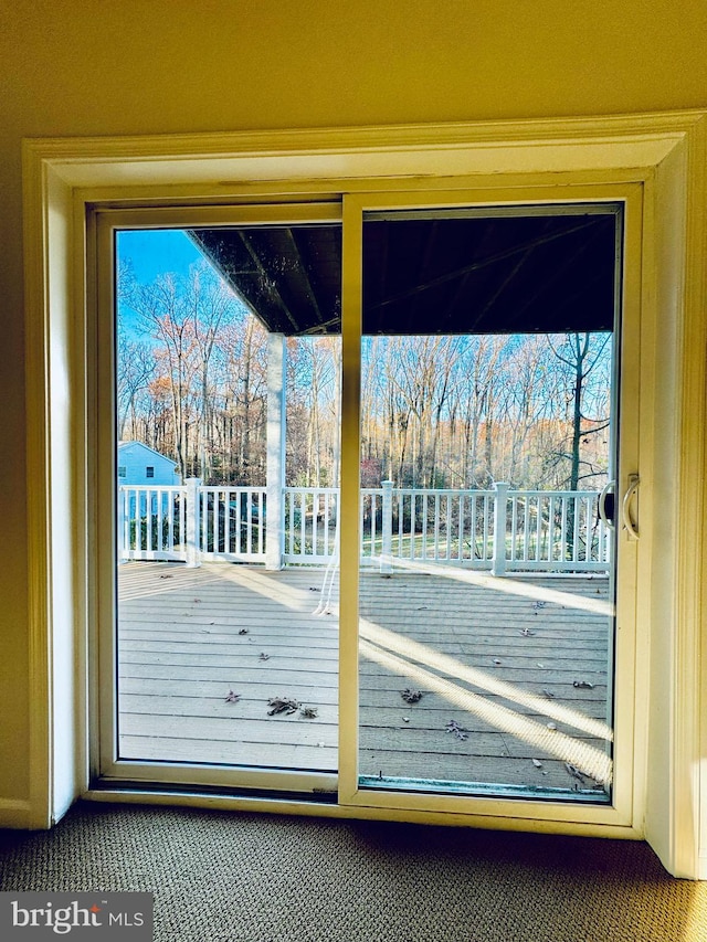 doorway featuring carpet flooring