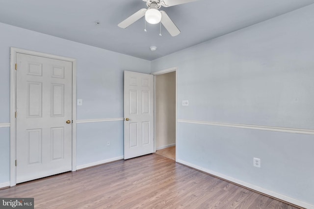 unfurnished bedroom with ceiling fan and light wood-type flooring