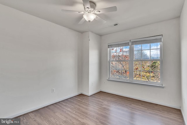 spare room with light hardwood / wood-style floors and ceiling fan