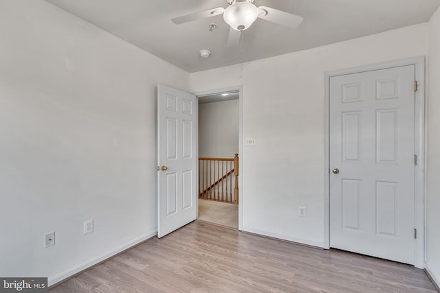 unfurnished bedroom with ceiling fan and light hardwood / wood-style floors