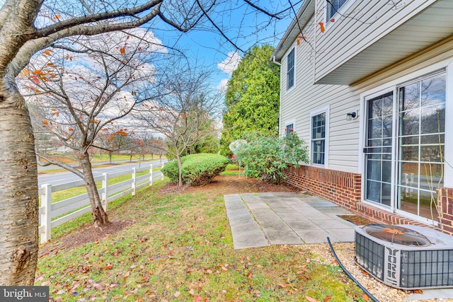 view of yard featuring central AC and a patio