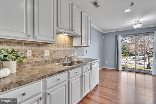 kitchen featuring white cabinetry, sink, and dishwasher