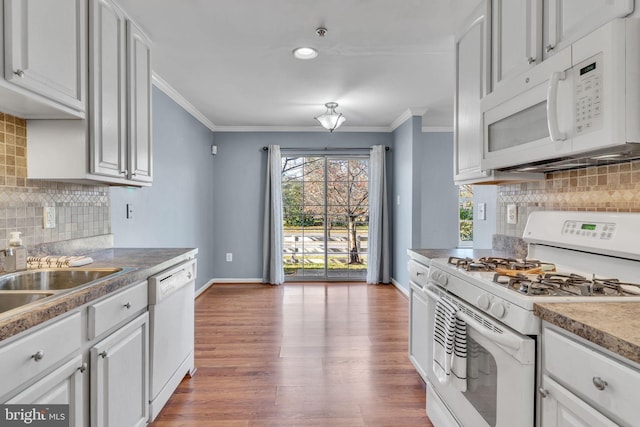 kitchen with white cabinets, white appliances, hardwood / wood-style floors, and tasteful backsplash