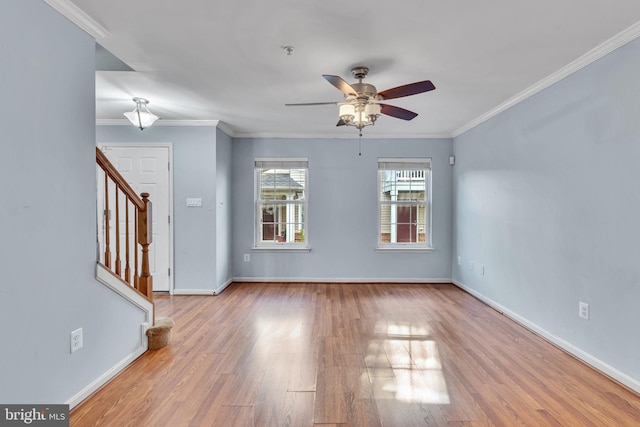 spare room with light wood-type flooring, ceiling fan, and ornamental molding