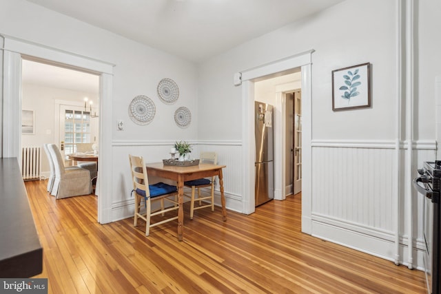 1411 W St, Annapolis, MD 21401 - dining area with radiator, wainscoting, and hardwood / wood-style flooring