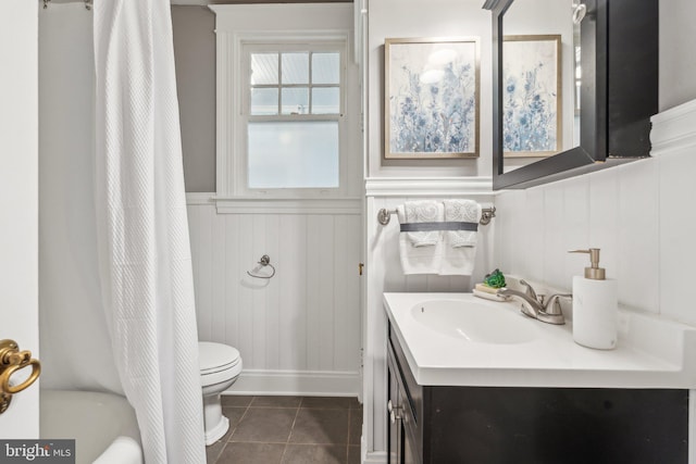1411 W St, Annapolis, MD 21401 - bathroom featuring toilet, tile patterned flooring, vanity, a decorative wall, and a wainscoted wall