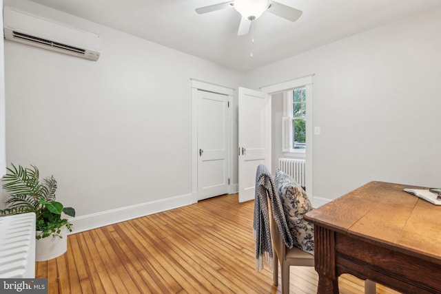 1411 W St, Annapolis, MD 21401 - office space featuring a ceiling fan, light wood-style flooring, a wall unit AC, baseboards, and radiator heating unit
