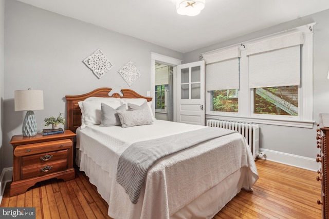 1411 W St, Annapolis, MD 21401 - bedroom with baseboards, radiator, and wood-type flooring