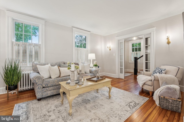 1411 W St, Annapolis, MD 21401 - living room featuring radiator, wood finished floors, baseboards, and stairs