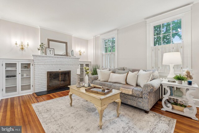 1411 W St, Annapolis, MD 21401 - living area with ornamental molding, a fireplace, and wood finished floors