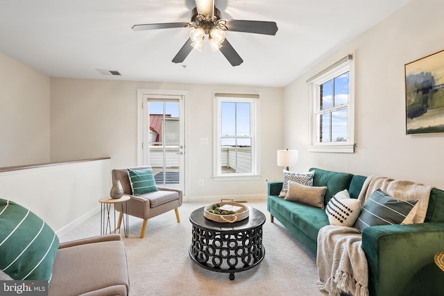 carpeted living room featuring ceiling fan