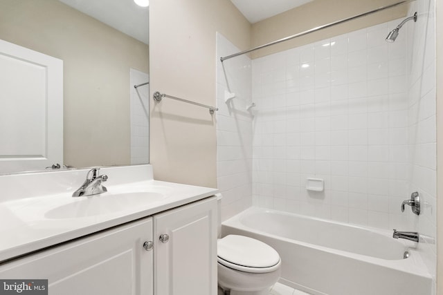 full bathroom with vanity, tiled shower / bath combo, and toilet