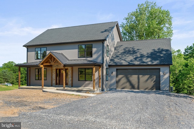 view of front facade with a porch and a garage