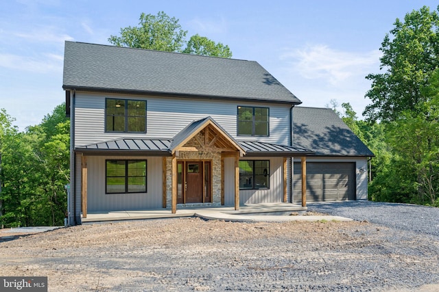 view of front facade with a porch and a garage