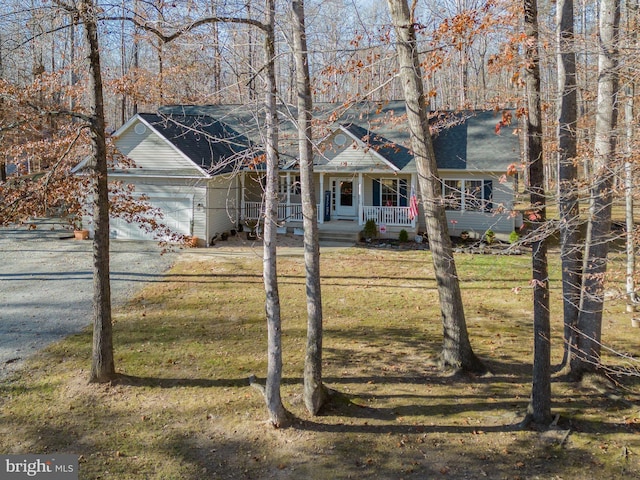 view of front of property with a porch, a front yard, driveway, and an attached garage