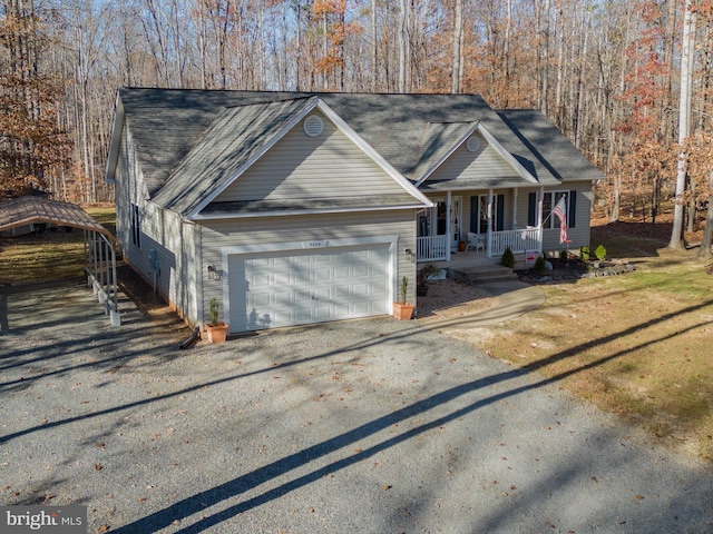 view of front of house with a porch, roof with shingles, driveway, and an attached garage