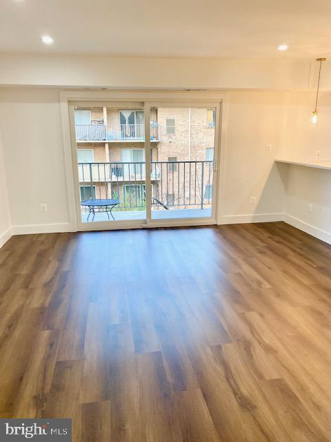 unfurnished room with dark hardwood / wood-style floors