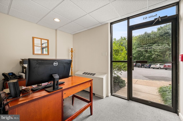 home office featuring carpet, a paneled ceiling, and a wealth of natural light