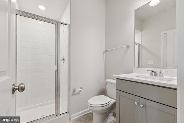 bathroom featuring tile patterned floors, vanity, toilet, and walk in shower